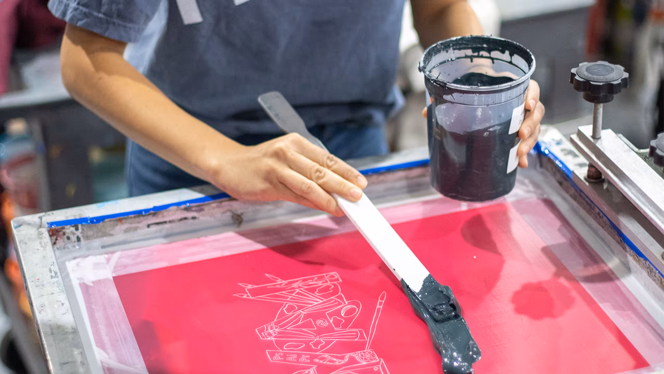 someone adding ink to a screen