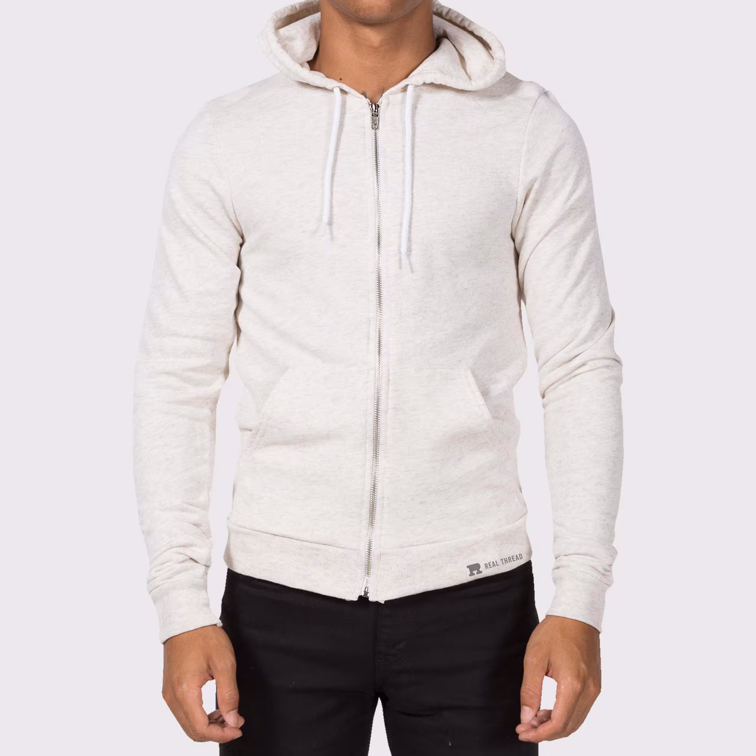 man wearing a light tan zip-up hoodie