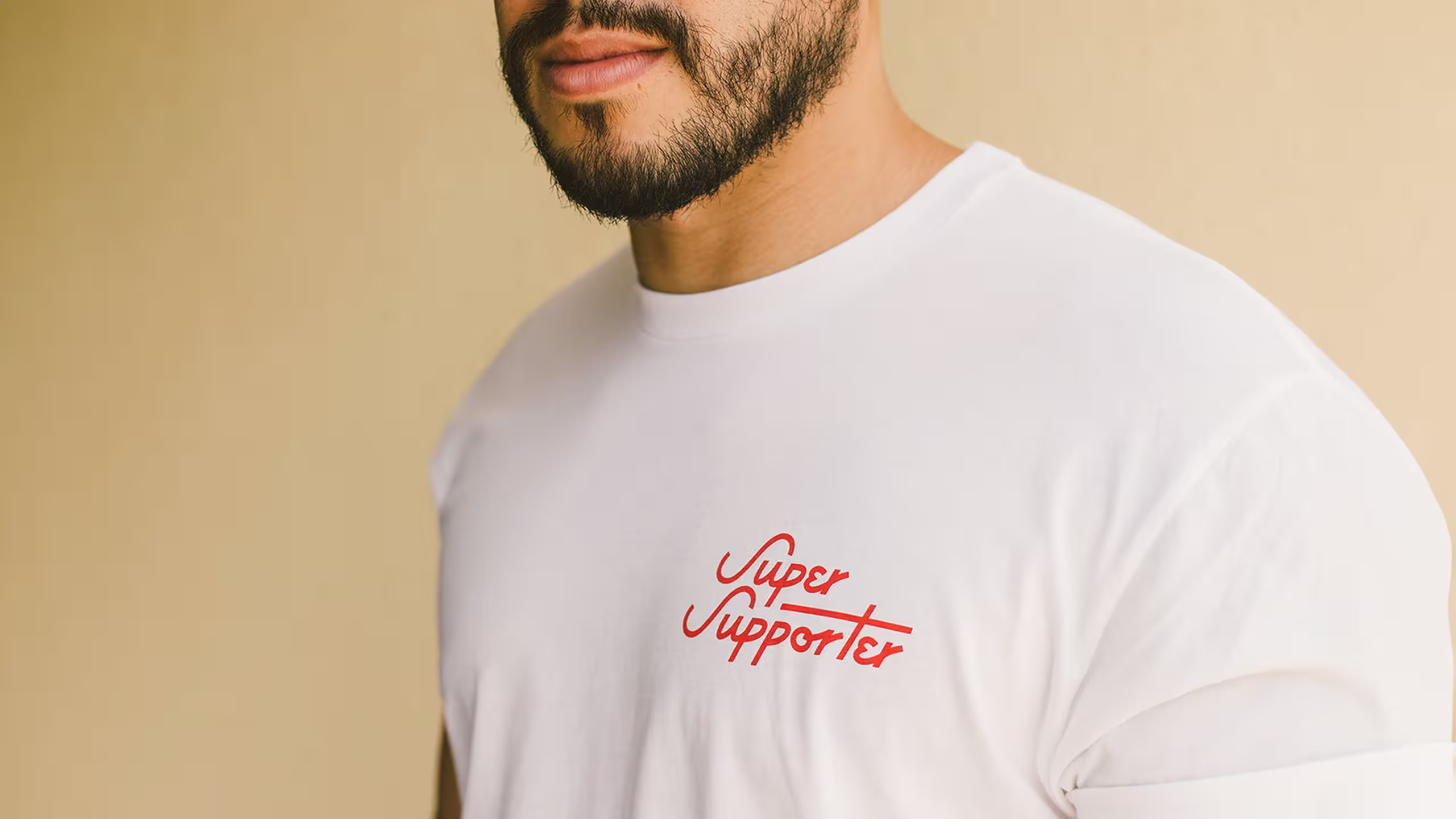 man wearing a white shirt with Super Supporter printed in red