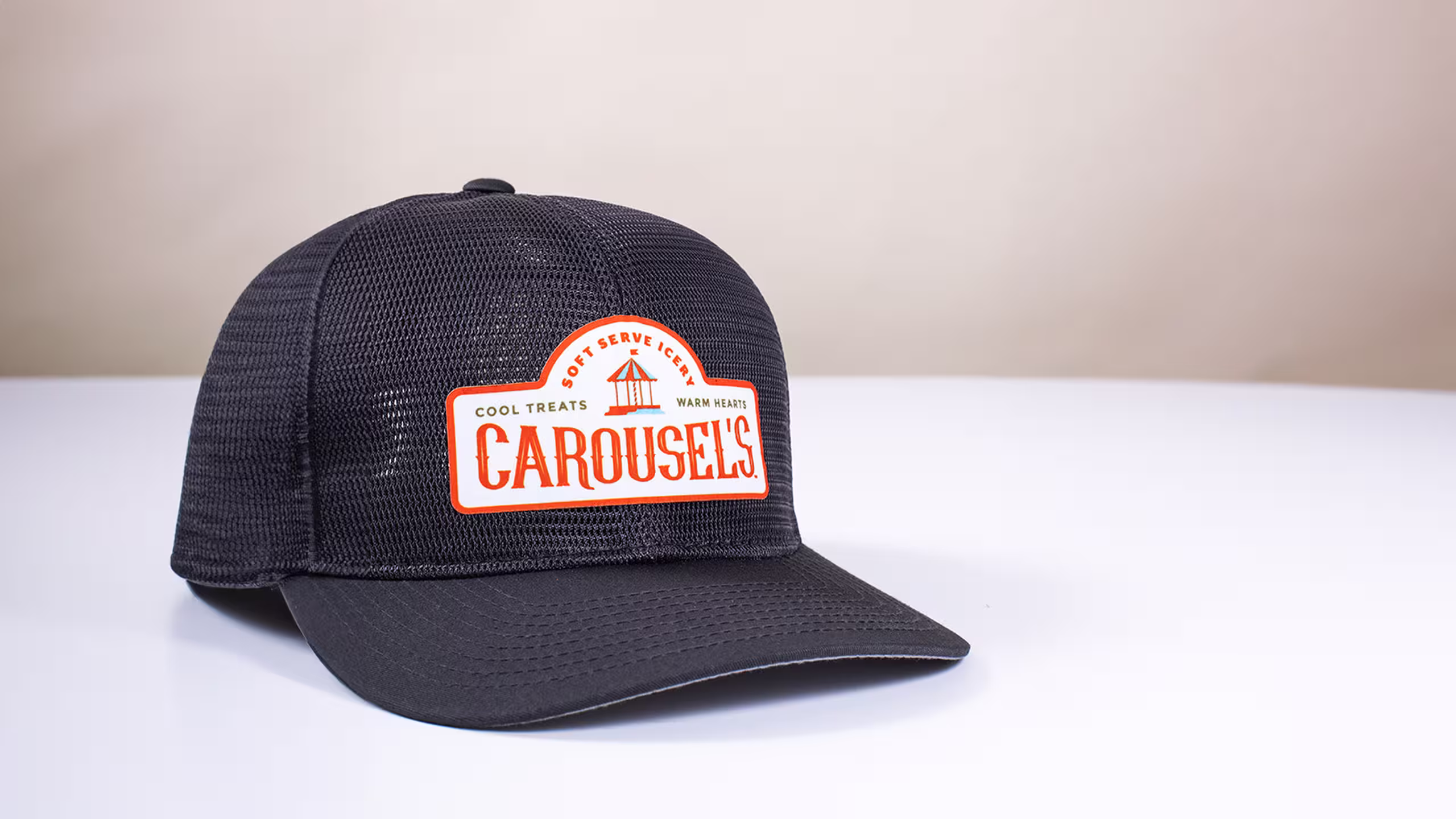 a black trucker hat sitting on a white table