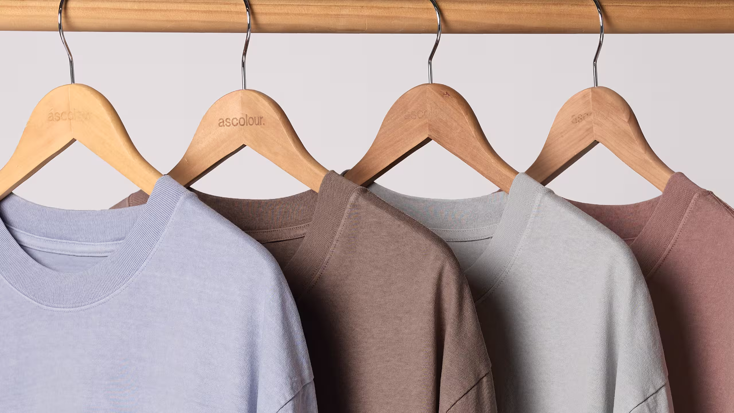 four heavyweight t-shirts hanging on a wooden hangers