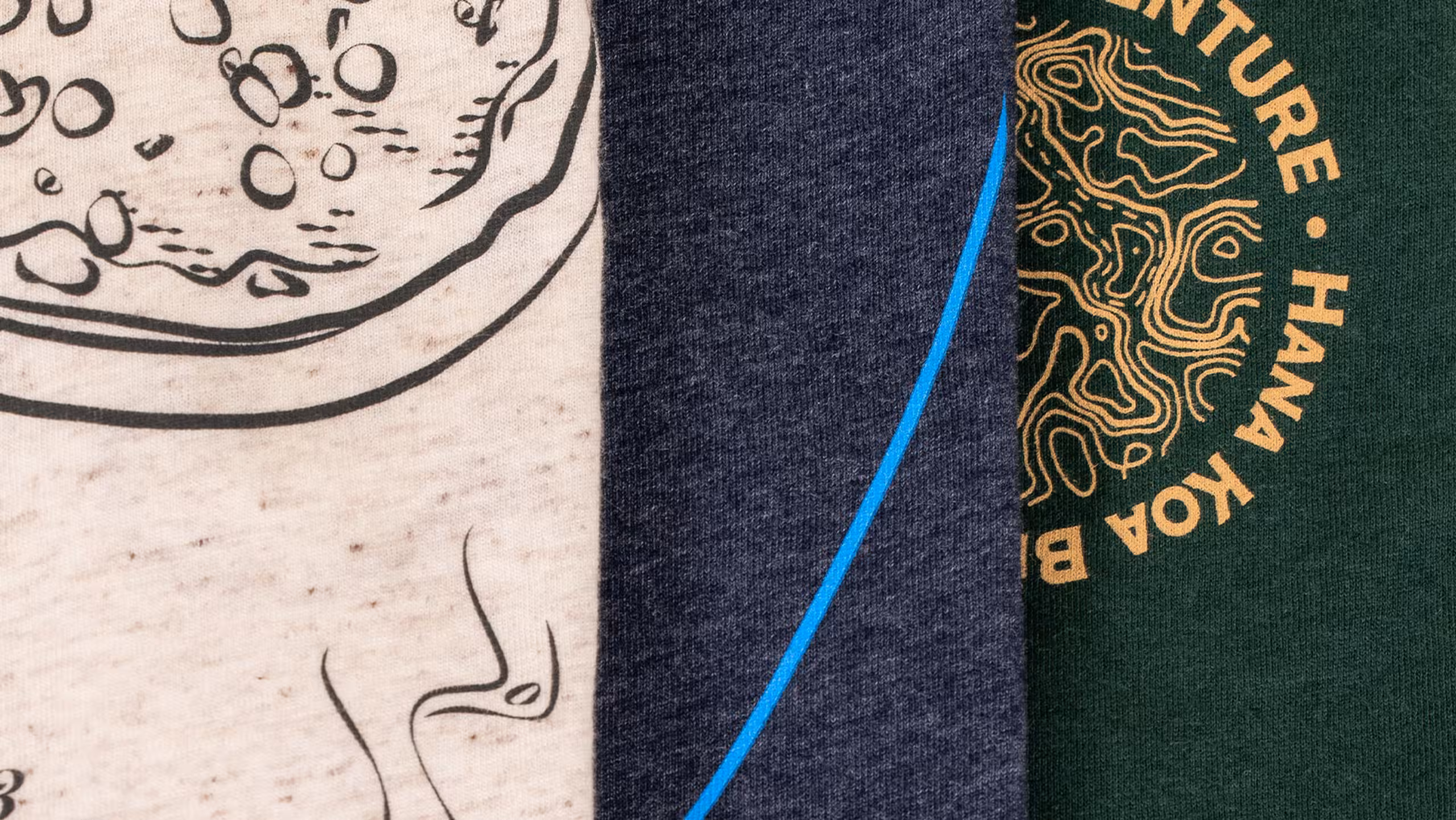 Close-up of three shirts. Left oat white, middle navy, and right dark green.