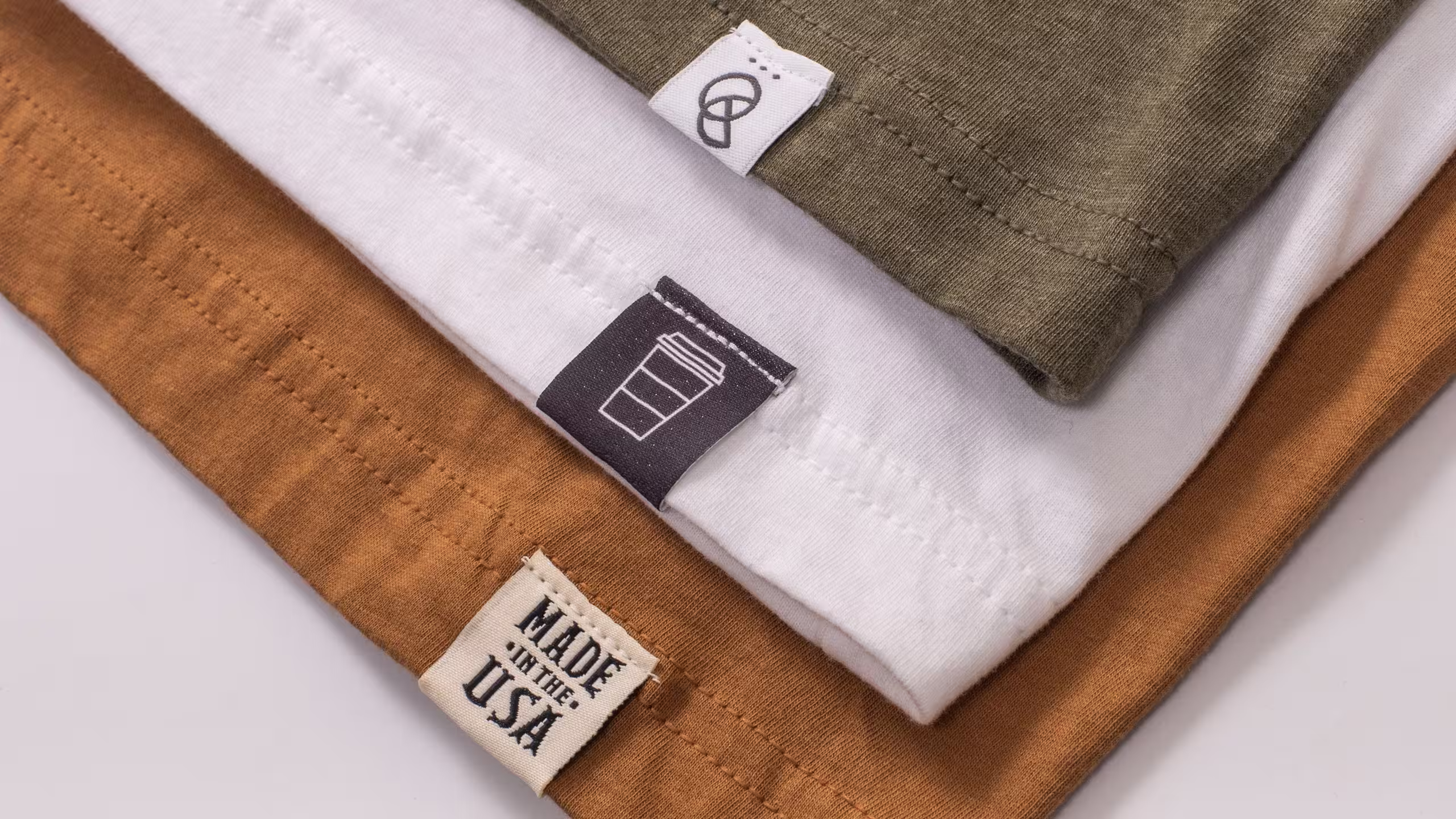 close up of three t-shirt with hem tags