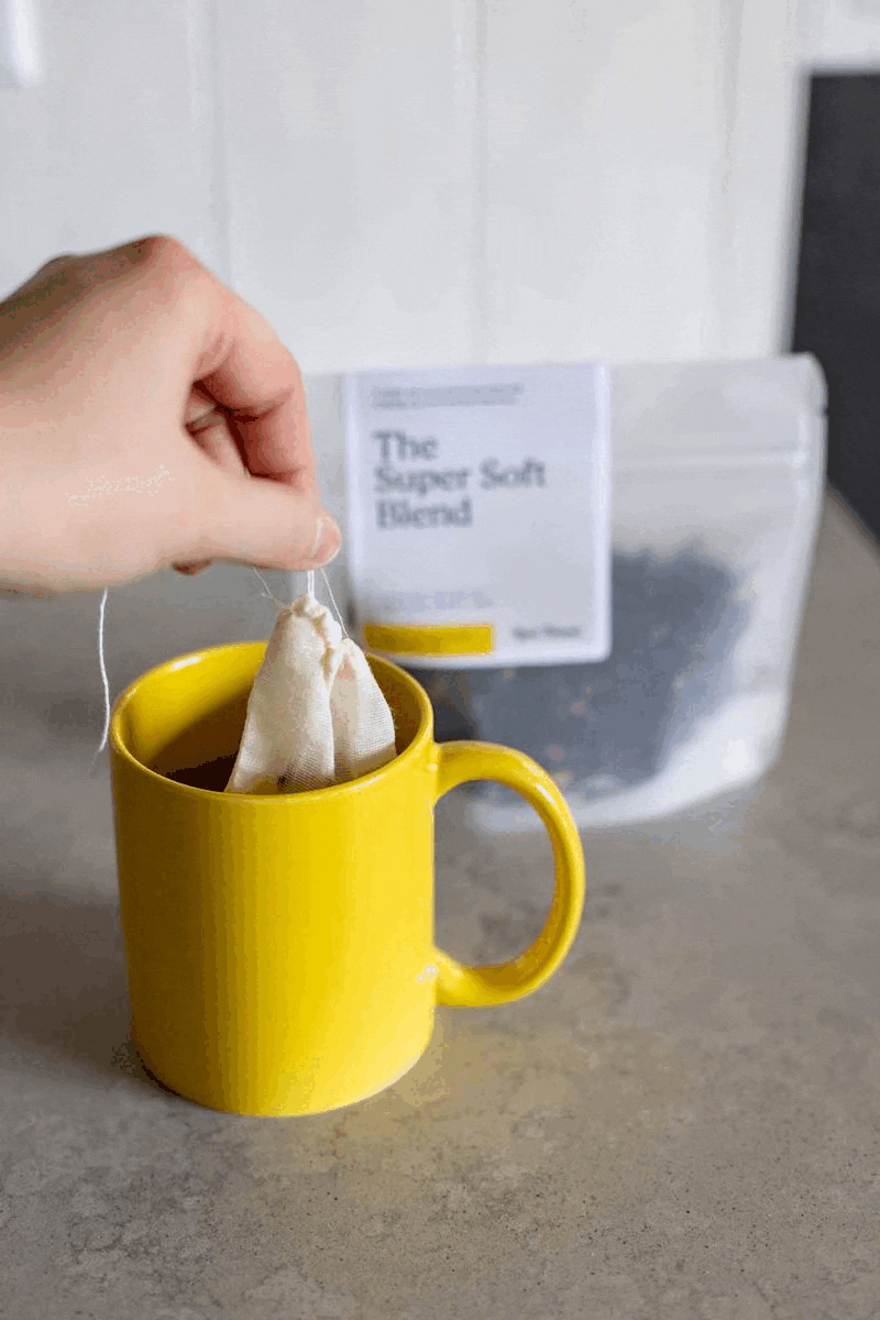 a hand dunks custom tea into a real thread yellow mug a hand dunks custom tea into a real thread yellow mug