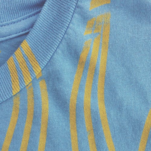 close of up yellow print seam of blue shirt close of up yellow print seam of blue shirt