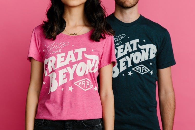 man and women posing in front of a pink background man and women posing in front of a pink background