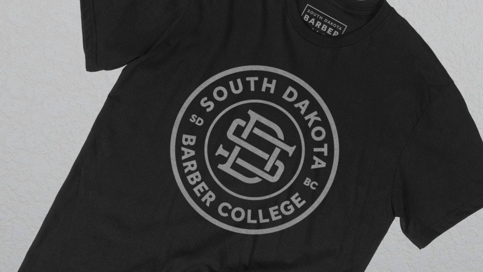 Black t-shirt with grey South Dakota college logo Black t-shirt with grey South Dakota college logo