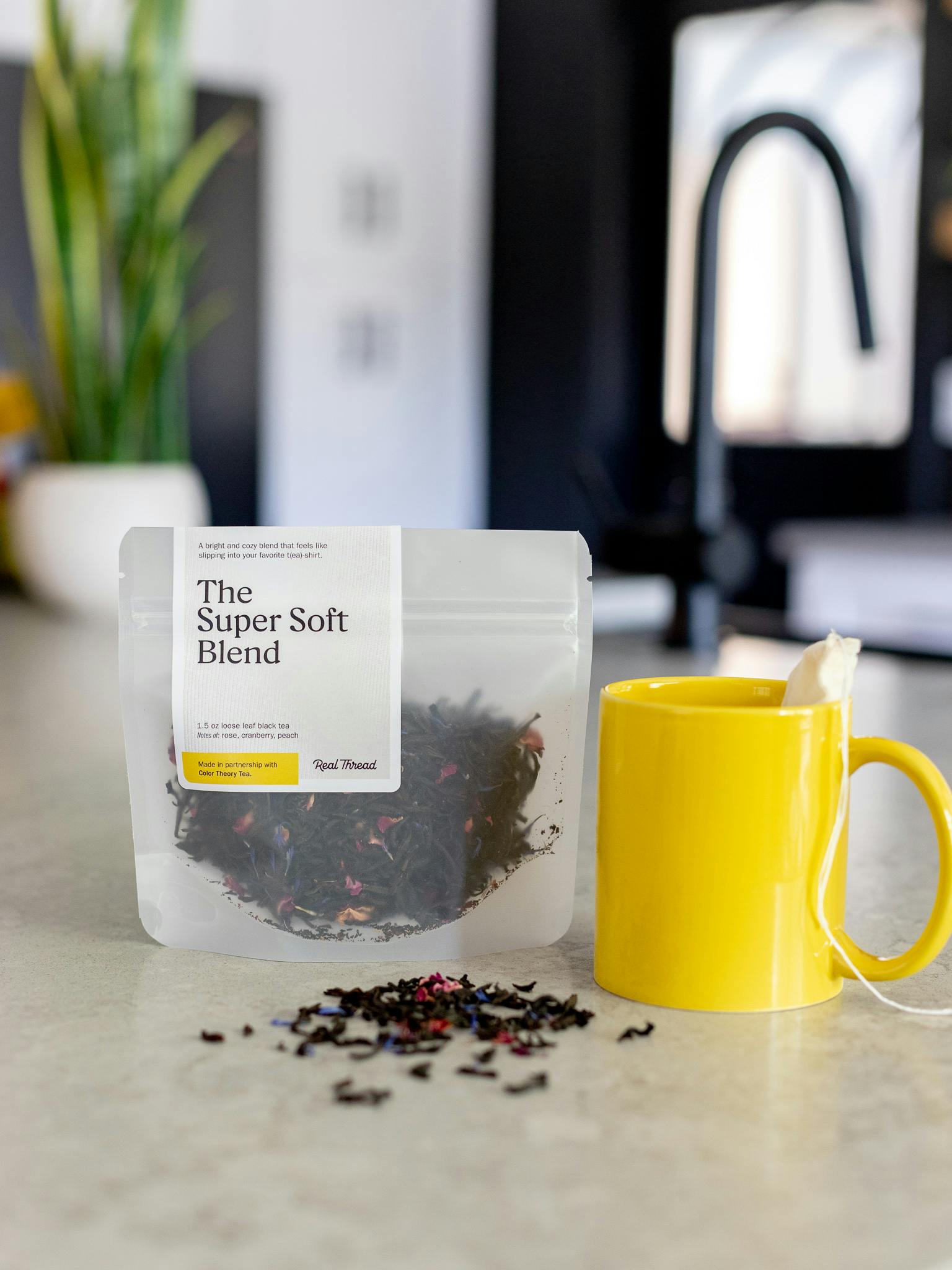 A package of Real Thread tea sits on a counter next to a mug A package of Real Thread tea sits on a counter next to a mug