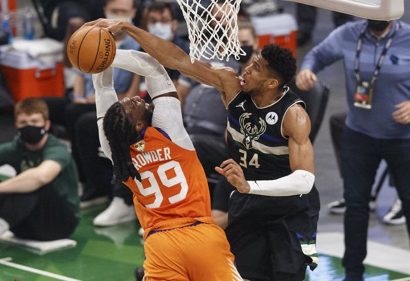 Basketball player blocking other player from scoring Basketball player blocking other player from scoring