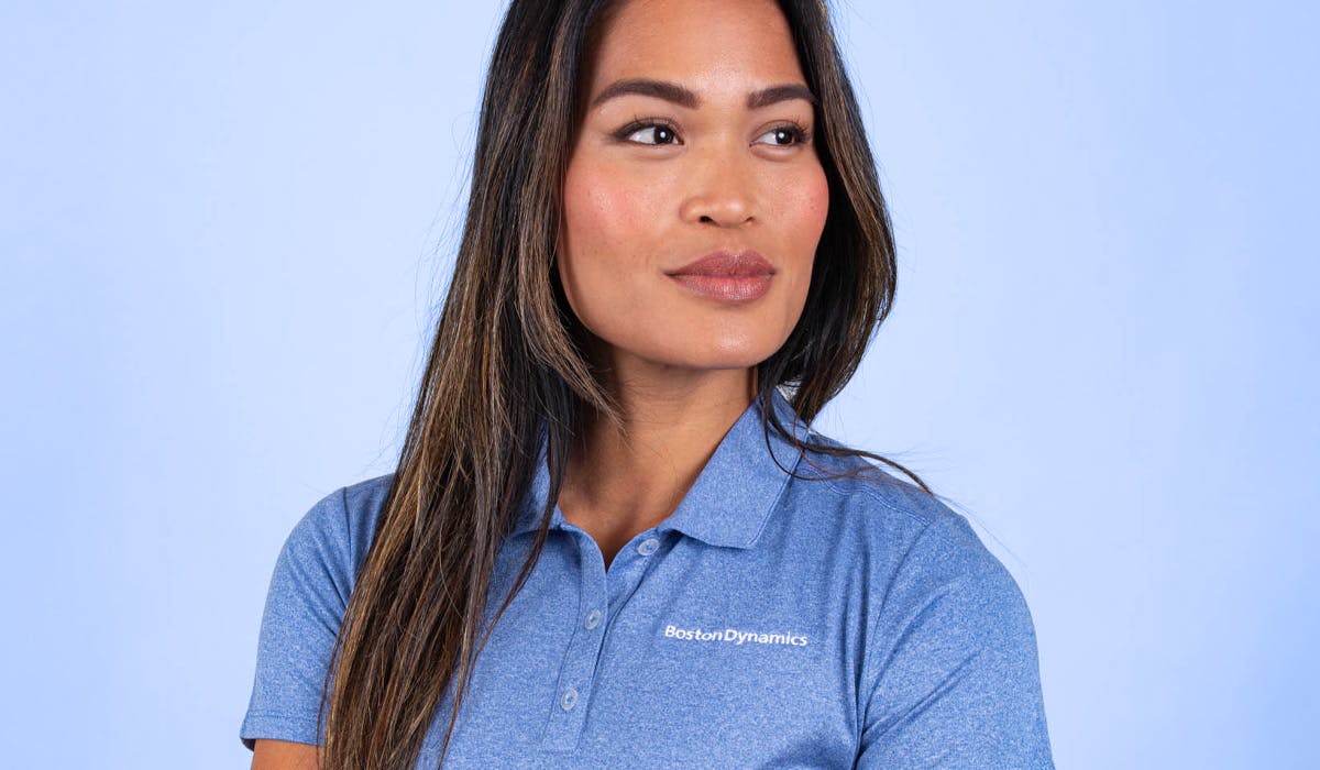 women wearing a blue polo with embroidered logo women wearing a blue polo with embroidered logo